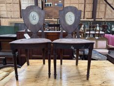 PAIR OF 19TH C. MAHOGANY HALL CHAIRS, shield back with inset cream painted panels depicting