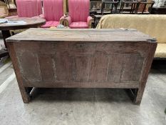 18TH C. JOINED OAK COFFER, hinged top above break arch panelled front, frieze carved 'TH 1746',