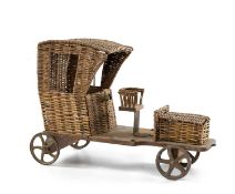 ANTIQUE WICKER TOY AUTOMOBILE, with rear cast iron wheels, 52cms (l) Comments: replaced front axle