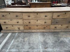 LARGE ANTIQUE PINE DRESSER BASE, triple plank top above arrangement of nine drawers, plinth base, 81
