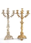 PAIR OF POLISHED WHITE METAL SEVEN-BRANCH CANDELABRAS, figural columns on Rococo tripod bases, one