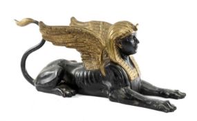 PARCEL GILT BRONZE EGYPTIAN SPHYNX, recumbent with raised wings, 102cms (l) Provenance: The Cornelia