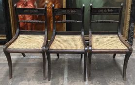 SET OF THREE REGENCY EBONISED DINING CHAIRS, backs with gilt metal appliqués above rope twist