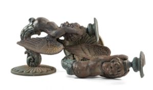 TEN CAST & PAINTED METAL FIGURAL WALL BRACKETS, modelled as winged putti, holding urns to their