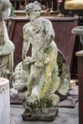RECONSTITUTED STONE FIGURAL FOUNTAIN OF NEPTUNE, standing beside a dolphin and water plants,