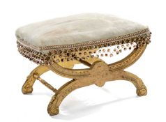 VICTORIAN GILT X-FRAME STOOL, stuffover seat on bowed supports with scrolled feet, 45 (h) x 61 (w) x