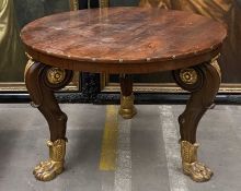EMPIRE STYLE PARCEL-GILT ROSEWOOD CENTRE TABLE, top edge with applied brass rosettes, four boldly