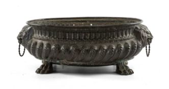 17TH C. STYLE EMBOSSED COPPER OVAL BASIN OR WINE COOLER, with loose ring lion's mask handles,