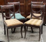 SET OF FOUR REGENCY MAHOGANY DINING CHAIRS, bowed and draped backs, drop-in seats, sabre legs, 88cms