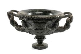 CARVED GREEN SERPENTINE MODEL OF WARWICK VASE, intertwined handles, on socle base, 33cms (w)