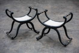 PAIR OF REGENCY STYLE EBONISED & PARCEL-GILT X-FRAMED STOOLS, scrolled frame joined by turned