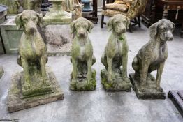 GROUP OF FOUR RECONSTITUTED STONE FIURES OF HOUNDS, all seated facing front, 73cms (h), one on