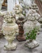 GROUP OF RECONSTITUTED STONE URNS, comprising set of four painted urns with floral finials, 80cms (