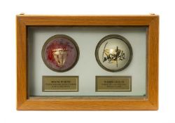 THE CRICKET CLUB HOUSE: PAIR MOUNTED SIGNED CRICKET BALLS, red ball signed by Shane Warne, white