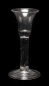 18TH C. WINE GLASS, trumpet bowl with rounded base, on tear enclosed stem and folded foot
