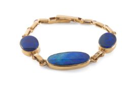 9CT GOLD BLACK OPAL BRACELET, three oval panels joined by two diamond set links, 18.5cms, 15g