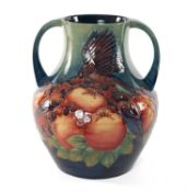 LARGE SALLY TUFFIN FOR MOORCROFT TWIN-HANDLED VASE, decorated in the 'Finches' pattern, 33.5cms