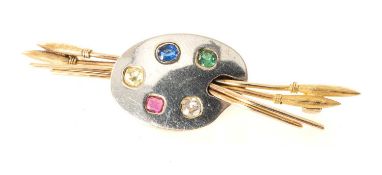 YELLOW & WHITE METAL ARTISTS' PALETTE & PAINTBRUSH BAR BROOCH, set with ruby, sapphire, emerald
