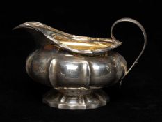 WILLIAM IV SILVER MILK JUG, London 1834, reeded shaped edge on melon form base and spreading foot