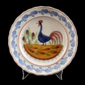 LLANELLY POTTERY COCKEREL PLATE, circa 1900, naively painted with a standing cockerel and plants