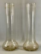 PAIR OF TALL CYLINDRICAL RIBBED GLASS VASES with flared bases, 61.5cms (h) Provenance: The