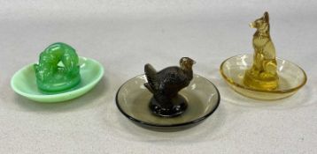 LALIQUE CIRCULAR FIGURAL DISHES, comprising smoked glass with turkey, amber glass with wolf, and