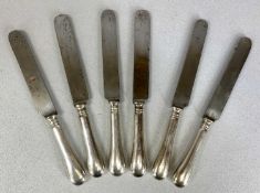 SET OF SIX CONTINENTAL WHITE METAL HANDLED DINNER KNIVES, stamped to the shoulders, stainless