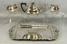 GEORGE V SILVER FOUR-PIECE TEA SERVICE, rectangular two-handle tray with wavy rim and inscription