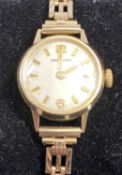 GARRARD 9CT GOLD LADIES' WRISTWATCH, 18mms dial on 9ct gold bracelet, with safety chain, 13.7gms