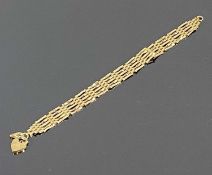 9CT GOLD GATE BRACELET with heart shaped locket, 16cms (l), 5.5gms Provenance: private collection
