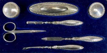 CASED SILVER SEVEN PIECE MANICURE SET of Art Deco form and with associated scissors, Birmingham 1922