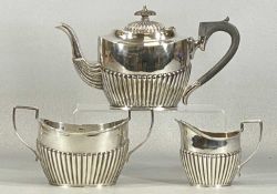 GEORGE V SILVER TEA SERVICE, oval form, gadrooned lower section, teapot with ebonised finial