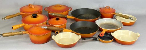 LE CREUSET COOKWARE, selection of orange enamelled cast iron pans and dishes