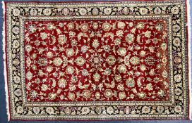 TABRIZ WOOL CARPET, red ground floral centre field 290 x 192cms