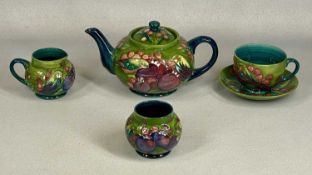 MOORCROFT FINCH & BERRIES TEA SET, on green ground, comprising circular squat teapot, milk jug