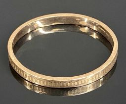 9CT ROSE GOLD HOLLOW BANGLE, with engraved decoration, 72 x 68mms, 10.7g