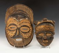 TWO CHOKWE MASKS, Zambia, one with large eye orbits 45cms (h), the other with triple bun coiffure,