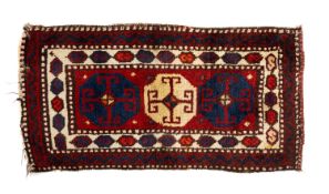 VINTAGE ANATOLIAN WOOL YASTIK, three octagonal guls with hooked motifs, on a madder field within