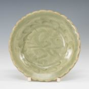 CHINESE LONGQUAN CELADON SAUCER, probably Song Dynasty, the combed waves centre within foliate