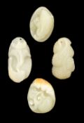 FOUR CHINESE JADE PEBBLE CARVINGS, including bat and peach, carp and lotus, three-legged toad, and