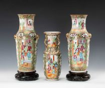 THREE CANTON FAMILLE ROSE VASES, including a pair with Buddhistic lion mask ring handles 30.4cms (