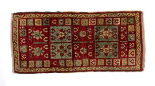 VINTAGE ANATOLIAN WOOL YASTIK, foliate compartmentalised field of star guls and v-shaped motifs,