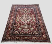 GOOD ISFAHAN RUG, floral madder field with dark spandrels, serrated leaf and flower guards, harshang