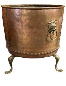 MASSIVE CIRCULAR COPPER CAULDRON, rivetted seams, brass lion mask ring handles, and paw feet, 85 (h)