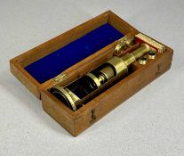 19TH CENTURY LACQUERED BRASS MONOCULAR MICROSCOPE, in fitted mahogany box with lenses and slides