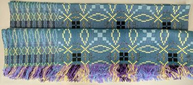 TRADITIONAL WELSH WOOLLEN BLANKET, in purple, blues, blacks, and greens, with tasselled ends, 204