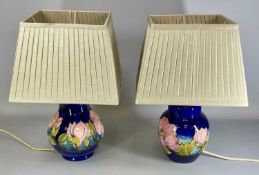 TWO MOORCROFT PINK MAGNOLIA PATTERN TABLE LAMPS, largest 26cms (h) excluding fittings, with