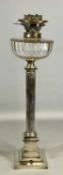 A WHITE METAL CORINTHIAN COLUMNED & STEPPED SQUARE BASE OIL LAMP with glass reservoir, 61cms tall