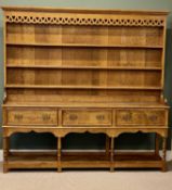 LARGE OAK WELSH DRESSER, boarded plate rack back with moulded cornice over pierced frieze, base with