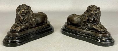 AFTER BARRIE pair of bronze figures of recumbent lions, on black marble bases, 25 (h) x 28cms (l)